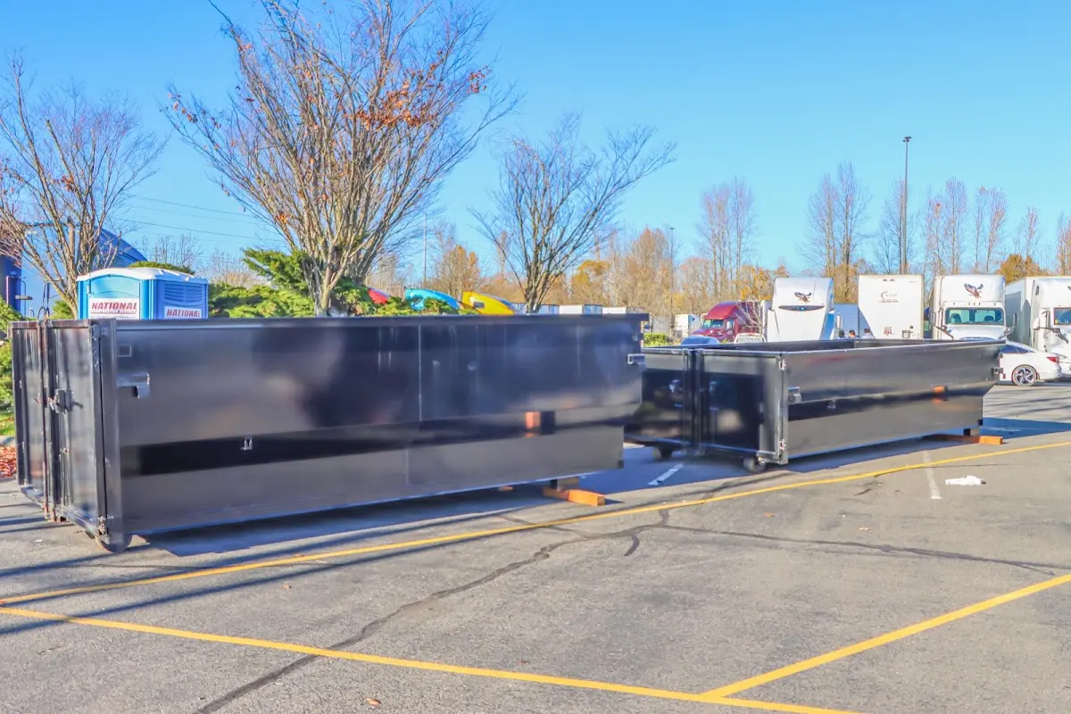 Professional dumpster rental service with roll-off container on residential driveway in Campbellsville